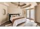 Serene bedroom featuring tray ceiling, modern decor, and French doors to the outdoors at 2709 E Vista Dr, Phoenix, AZ 85032