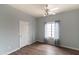 Light and airy bedroom with hardwood floors, light walls, and a ceiling fan at 2709 E Vista Dr, Phoenix, AZ 85032