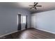 Cozy bedroom with wood-look floors and a ceiling fan for comfortable living at 2709 E Vista Dr, Phoenix, AZ 85032