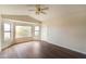 Bright bedroom features natural light, wood-look floors, and a ceiling fan at 2709 E Vista Dr, Phoenix, AZ 85032