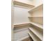 Walk-in closet with custom built-in shelves and wood-look floors at 2709 E Vista Dr, Phoenix, AZ 85032