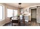 Charming dining area featuring a glass table, modern lighting, and a sliding barn door at 2709 E Vista Dr, Phoenix, AZ 85032