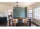 Elegant dining room with a wood table, stylish chairs, modern lighting, and shiplap accent wall at 2709 E Vista Dr, Phoenix, AZ 85032