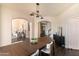 Inviting dining room featuring wood table, stylish lighting, and views into the living room at 2709 E Vista Dr, Phoenix, AZ 85032