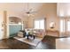 Bright living room features a large sectional sofa, modern fan, and decorative fireplace at 2709 E Vista Dr, Phoenix, AZ 85032