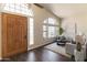 Bright living room with a vaulted ceiling, large windows, and wood-look flooring at 2709 E Vista Dr, Phoenix, AZ 85032