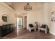 Neutral living room featuring an ornate chandelier and wood-look floors at 2709 E Vista Dr, Phoenix, AZ 85032