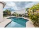 Private backyard pool offers a refreshing escape, complemented by mature trees and blooming yellow shrubs at 2709 E Vista Dr, Phoenix, AZ 85032