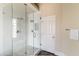 Shower with glass door, a rainfall shower head, and white marble tile at 2709 E Vista Dr, Phoenix, AZ 85032