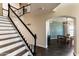 Bright staircase with wood and white banister leading to an open-concept dining area with stylish decor at 2709 E Vista Dr, Phoenix, AZ 85032