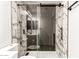 Stylish bathroom with marble tile shower, modern vanity, and sleek fixtures at 2710 S Shelby --, Mesa, AZ 85209