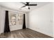 Bright bedroom with wood floor, window with blinds and dark curtains at 2710 S Shelby --, Mesa, AZ 85209