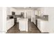 Modern kitchen with white cabinetry, stainless steel appliances, marble countertops, and wood floors at 2710 S Shelby --, Mesa, AZ 85209