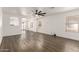 Spacious living room features wood flooring, white walls, a modern ceiling fan, and abundant natural light at 2710 S Shelby --, Mesa, AZ 85209