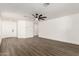 Spacious living room features wood flooring, white walls, a modern ceiling fan, and abundant natural light at 2710 S Shelby --, Mesa, AZ 85209