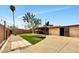 Spacious backyard with a mix of hardscaping and artifical turf, mature trees, and covered patio at 2907 W Townley Ave, Phoenix, AZ 85051