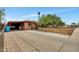 Home featuring a covered parking area and a fenced front yard, set under a clear blue sky at 2907 W Townley Ave, Phoenix, AZ 85051