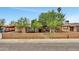Charming home featuring a well-manicured lawn, mature trees, and a quaint picket fence at 2907 W Townley Ave, Phoenix, AZ 85051