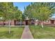Landscaped front yard with mature trees and a walkway leading to the front door at 2907 W Townley Ave, Phoenix, AZ 85051