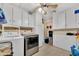 Bright laundry room with white cabinets, washer, dryer, ceiling fan, and neutral plank flooring at 2907 W Townley Ave, Phoenix, AZ 85051