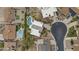 A birdseye aerial of a home with a private swimming pool, lush trees and landscaping and neighborhood streets at 2916 S Revere Cir, Mesa, AZ 85210