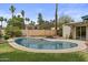 Large swimming pool with lush landscaping surrounding a well-maintained grassy backyard at 2916 S Revere Cir, Mesa, AZ 85210