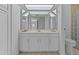 This bathroom features white cabinets and tiled flooring with a large vanity mirror and great natural light at 2916 S Revere Cir, Mesa, AZ 85210