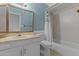 Bathroom featuring blue walls, a large mirror, a white sink vanity, a toilet and a shower with tub at 2916 S Revere Cir, Mesa, AZ 85210