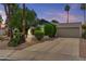 Charming home exterior with a well-maintained lawn, mature trees, and attached two-car garage at 2916 S Revere Cir, Mesa, AZ 85210