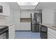 Well-lit kitchen with stainless steel appliances, custom cabinetry, and modern finishes at 2916 S Revere Cir, Mesa, AZ 85210