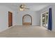 Bright living room with an archway leading to another room and a sliding glass door to the outside at 2916 S Revere Cir, Mesa, AZ 85210