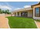 Landscaped backyard featuring covered patio and artificial turf at 2994 E Mahogany Pl, Chandler, AZ 85249