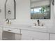 Bathroom with double sink vanity, black fixtures, marble countertops, and arched mirrors at 2994 E Mahogany Pl, Chandler, AZ 85249