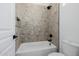 Tiled bathtub and shower featuring black fixtures in a modern bathroom setting at 2994 E Mahogany Pl, Chandler, AZ 85249