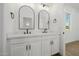 Modern bathroom featuring double vanities with black fixtures and arched mirrors at 2994 E Mahogany Pl, Chandler, AZ 85249