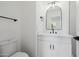 Modern bathroom featuring black fixtures, single vanity, and a decorative light fixture at 2994 E Mahogany Pl, Chandler, AZ 85249