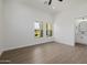 Bright bedroom featuring two windows and wood flooring, complemented by an ensuite bathroom at 2994 E Mahogany Pl, Chandler, AZ 85249