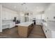 Stylish kitchen features white cabinets, a large center island, and modern pendant lighting at 2994 E Mahogany Pl, Chandler, AZ 85249