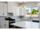 Kitchen features stainless appliances, white cabinetry, and a view to the exterior at 2994 E Mahogany Pl, Chandler, AZ 85249
