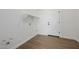 Bright laundry room with a shelf and wooden floors at 2994 E Mahogany Pl, Chandler, AZ 85249