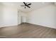 Large, airy living room with wood floors, neutral walls, arched doorway, ceiling fan, and many windows at 2994 E Mahogany Pl, Chandler, AZ 85249