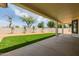 Covered patio overlooking manicured lawn with palm trees at 2994 E Mahogany Pl, Chandler, AZ 85249