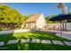 Charming backyard with a pool, lush landscaping, a shed and a patio with comfortable seating at 3133 E Claire Dr, Phoenix, AZ 85032