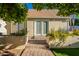 Backyard with French doors, lush landscaping, and a brick walkway leading to the entrance at 3133 E Claire Dr, Phoenix, AZ 85032