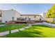 Stunning backyard featuring artificial turf, a deck, and outdoor seating at 3133 E Claire Dr, Phoenix, AZ 85032