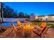 Inviting backyard featuring a pool, firepit, and comfortable seating at 3133 E Claire Dr, Phoenix, AZ 85032