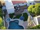 Aerial view of an inviting backyard pool, spa, patio, wooden deck and artificial turf, perfect for outdoor living at 3133 E Claire Dr, Phoenix, AZ 85032