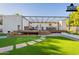 Inviting backyard featuring an outdoor living area, a deck, and artificial turf at 3133 E Claire Dr, Phoenix, AZ 85032