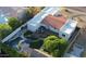 Aerial view showcasing a backyard with a pool, spa, wooden deck, artificial turf, and a cozy patio area at 3133 E Claire Dr, Phoenix, AZ 85032