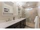 Modern bathroom featuring double sinks, a tiled shower, and sleek fixtures at 3133 E Claire Dr, Phoenix, AZ 85032